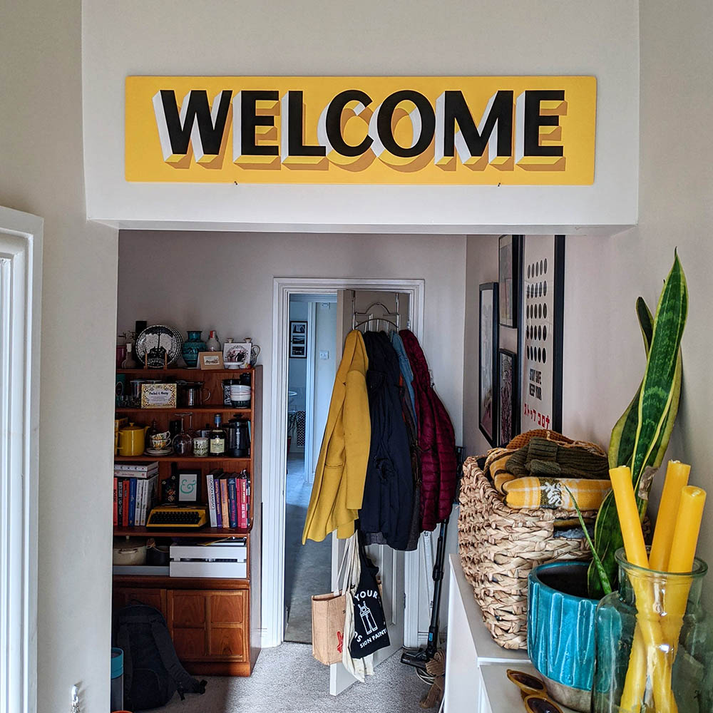 welcome_sign_handpainted_yellow_signwriting